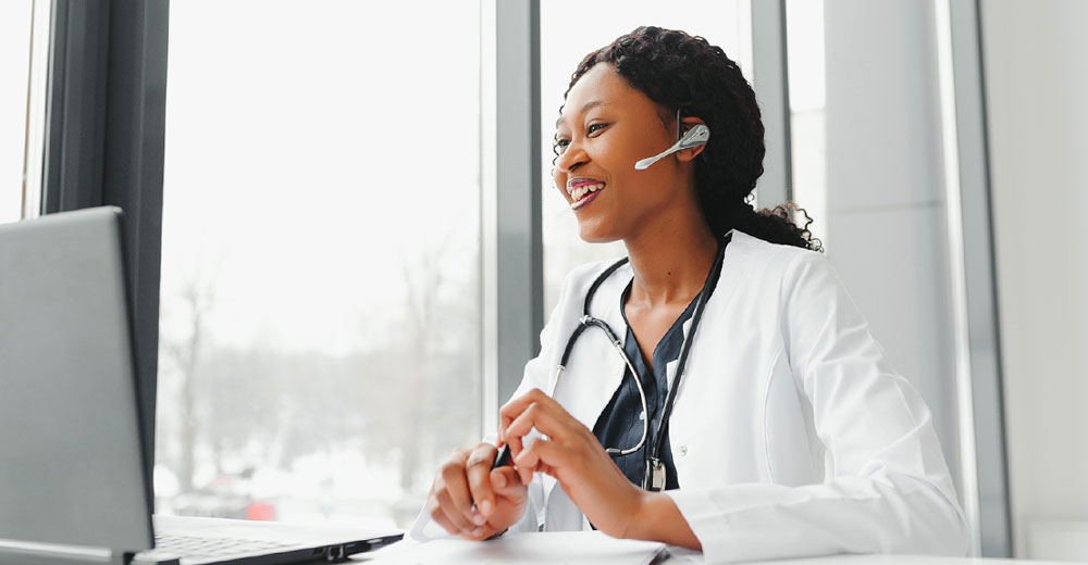 medical doctor providing digital health care services remotely on a computer